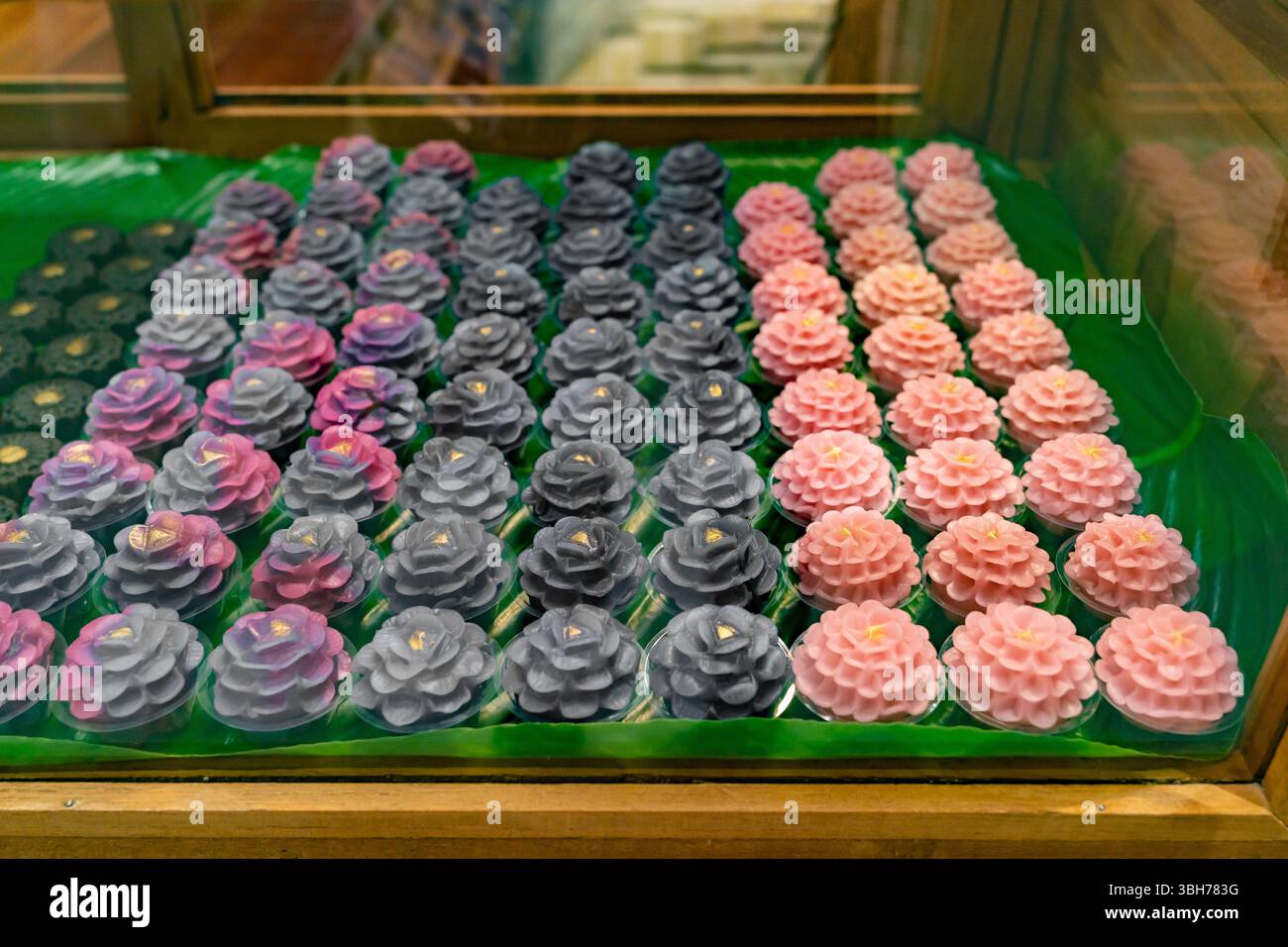 Display of intricately crafted Thai desserts called Khanom Chor Muang. Stock Photo