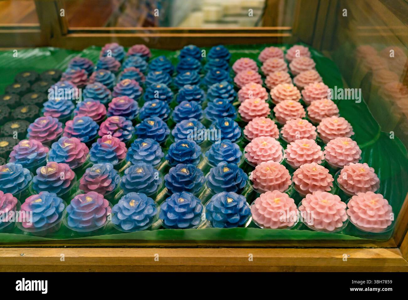 Display of intricately crafted Thai desserts called Khanom Chor Muang. Stock Photo