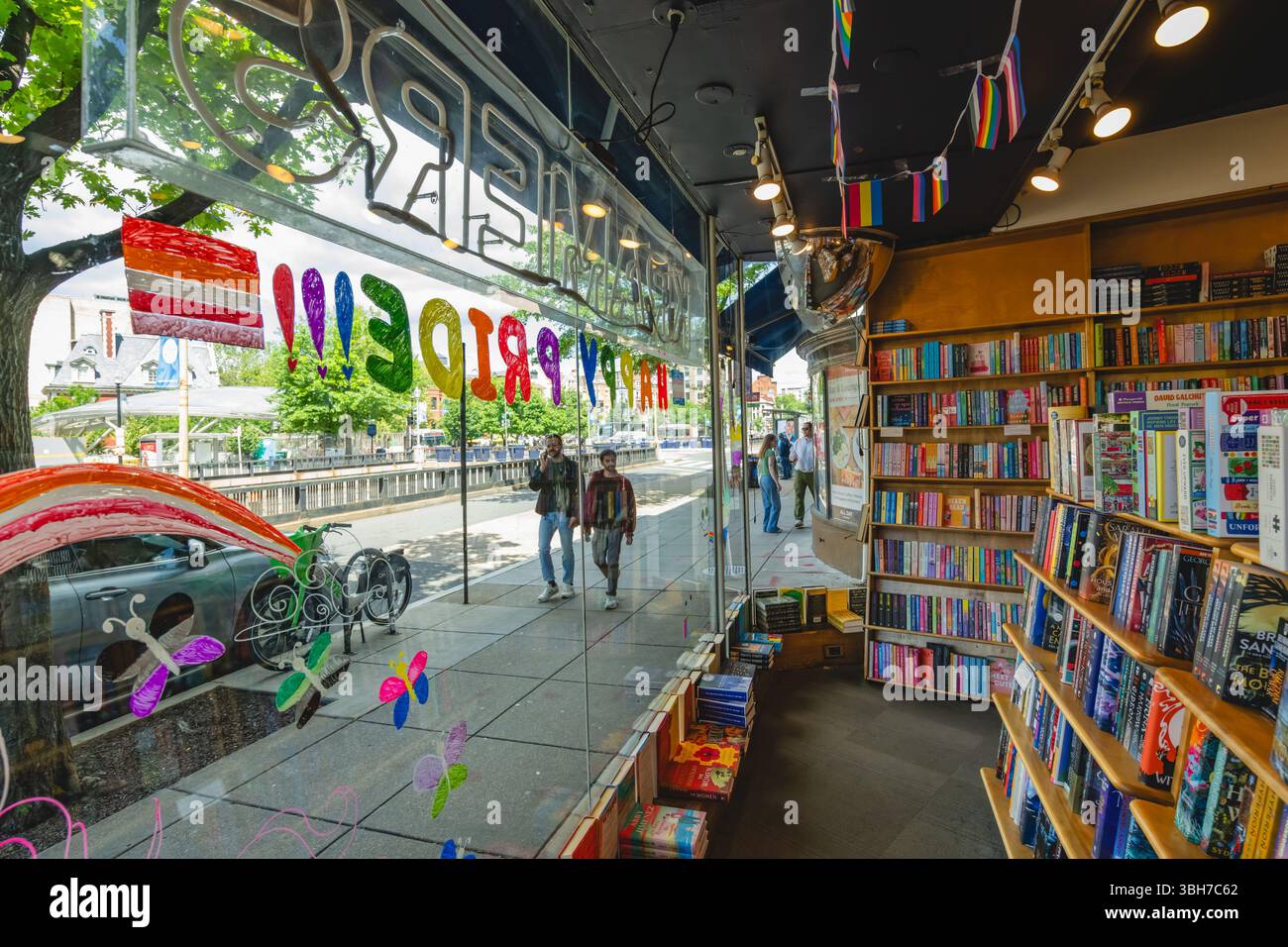 Washington D.C., USA, - May 23, 2025 - Wide exterior view of a welcoming Kramers bookshop with books filling the window display, rainbow heart cutouts Stock Photo