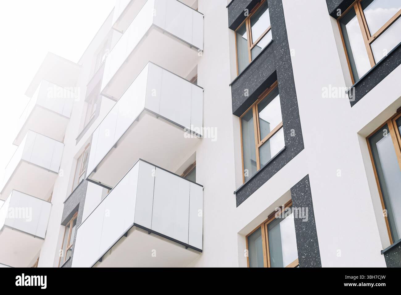 White modern apartment building. Contemporary housing facade with large ...