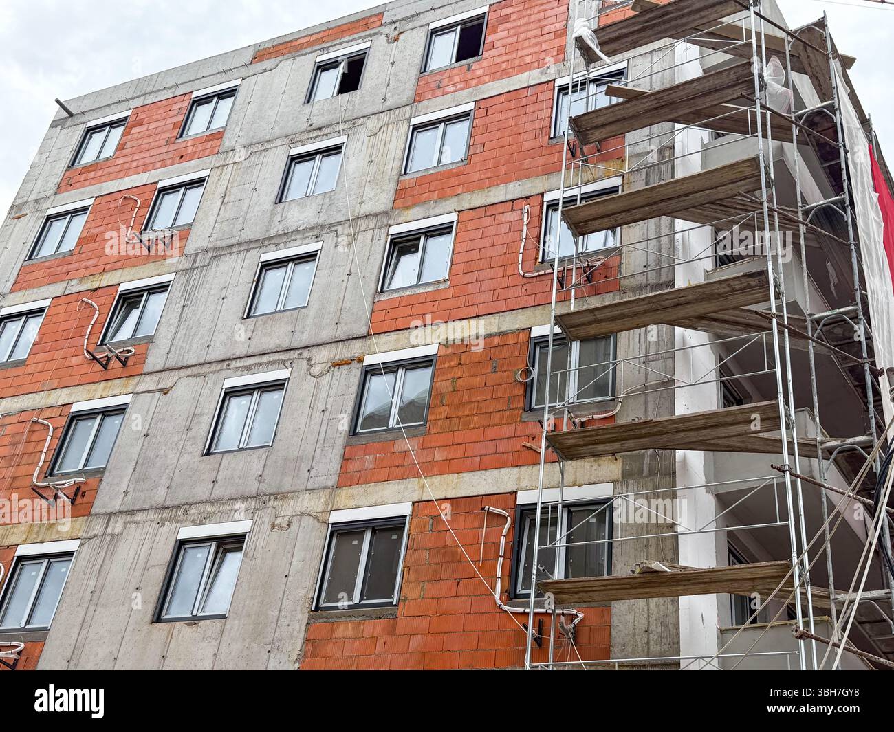 Photo inspiration: Fresh Look at Facade Of A Multi Story Residential Building Under Construction