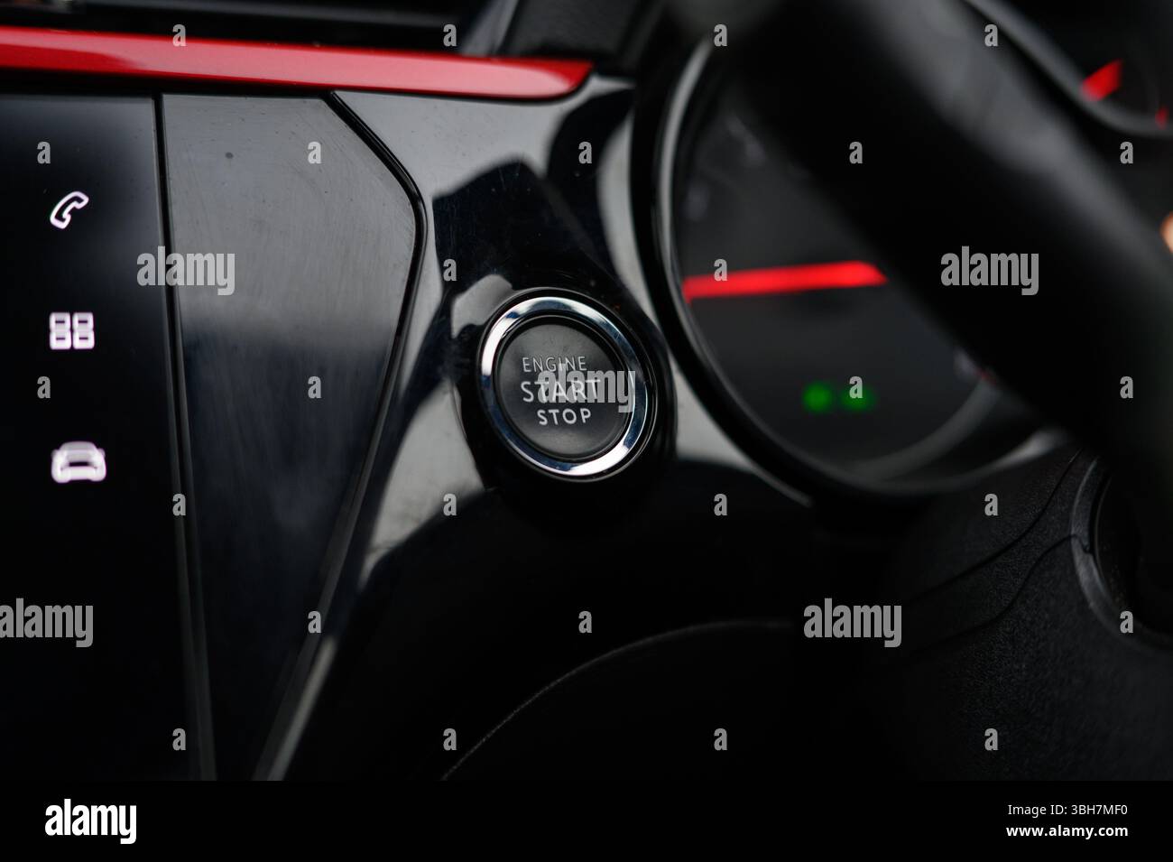 A car's dashboard with a start button and a stop button. The buttons are black and red Stock Photo