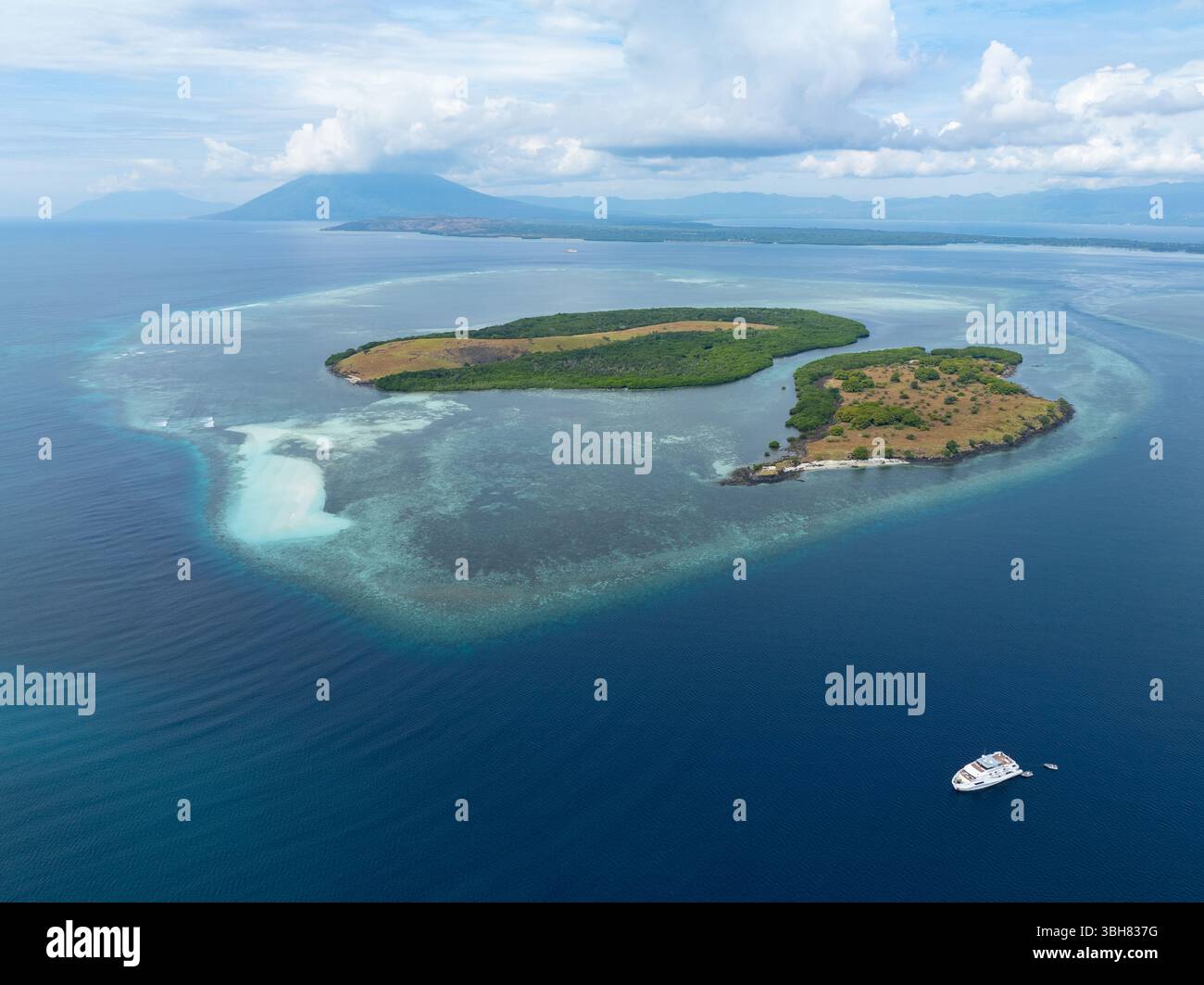 Healthy coral reefs surround scenic islands off the coast of Adonara in ...
