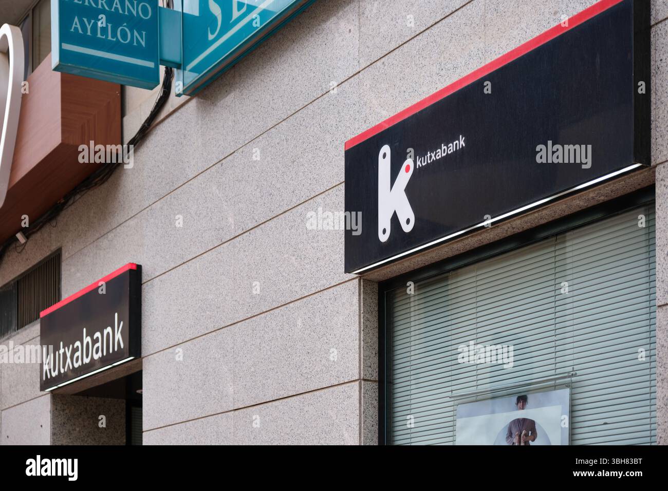 Close-up of Kutxabank sign on a building facade with modern typography and simple design. Av. Academia de Infantería, 28, 30008 Murcia, Spain Stock Photo