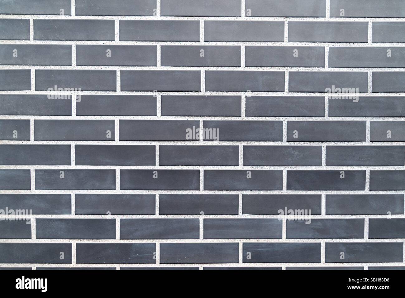 Black brick wall with uniform rectangular pattern. Stock Photo