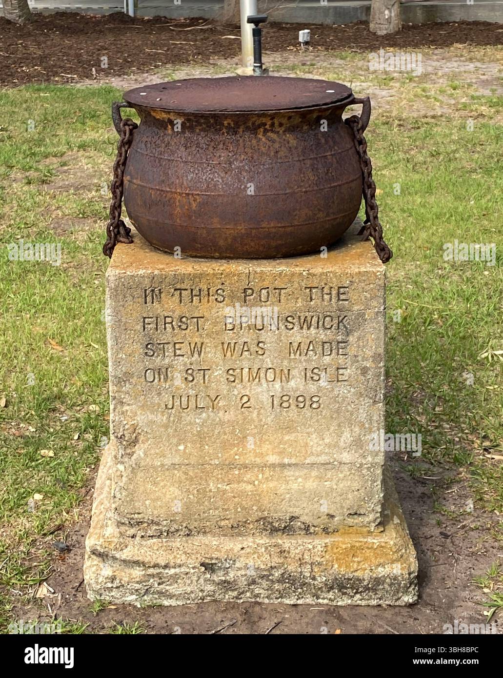 A rusty stewpot that was used to make the first Brunswick Stew on St Simons Island by a group of hunters in 1898. - Smartphone Captured Stock Image