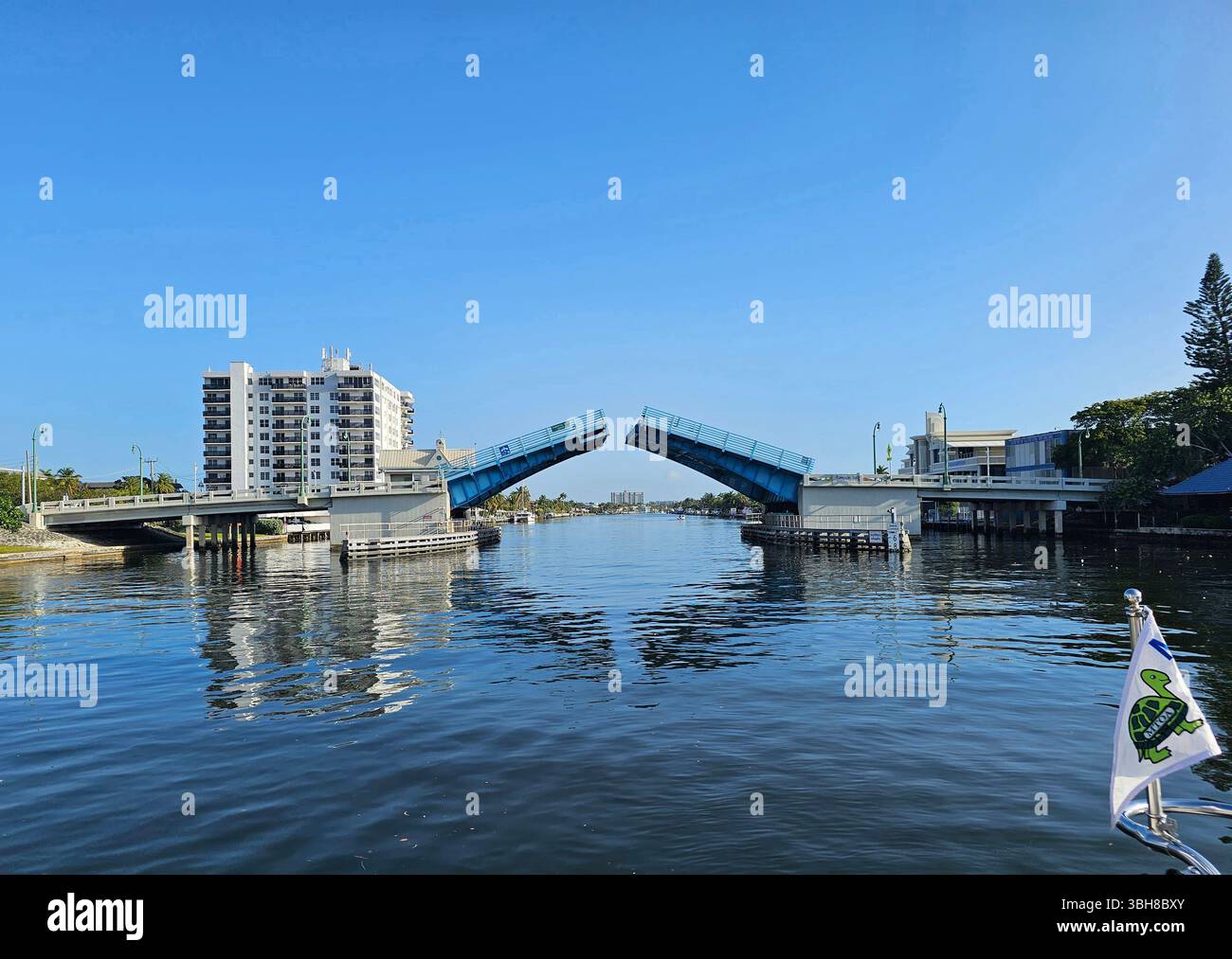 Intracoastal Waterway bridge opening in Fort Lauderdale, Florida. The bridge at E. Commercial Boulevard is opening for a pleasure boat. - Smartphone Captured Stock Image