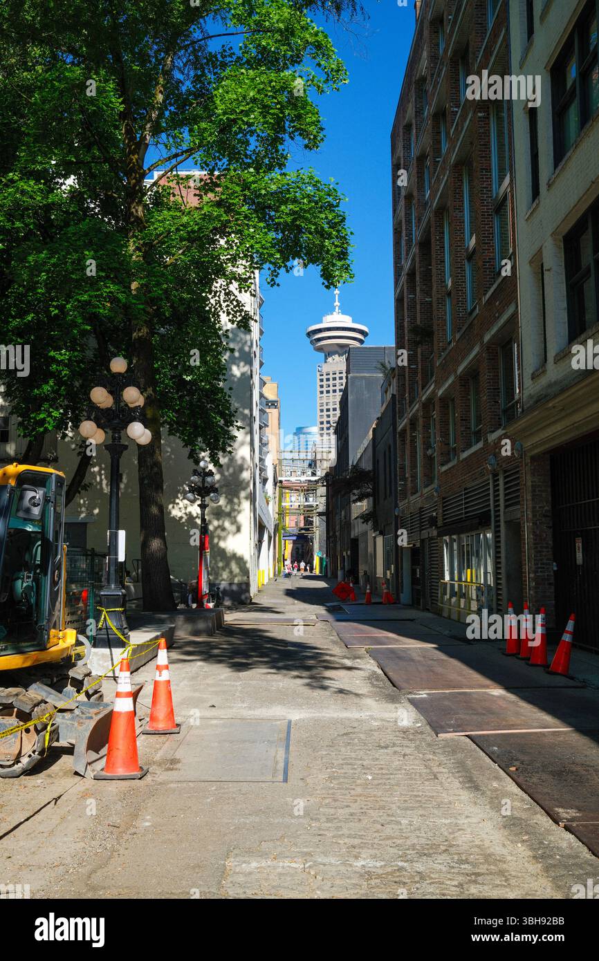 Trounce Alley, more commonly known as Blood Alley, in Gastown, Vancouver, BC with the Vancouver Lookout tower in the distance. Stock Photo