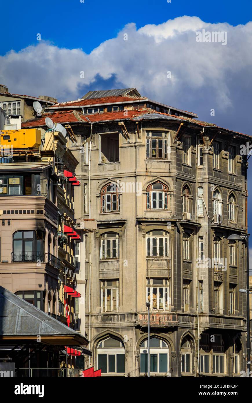 A historic, Ottoman style building with classical elements, weathered facade, signs of age and neglect in the Fatih neighborhood of Istanbul, Turkey Stock Photo