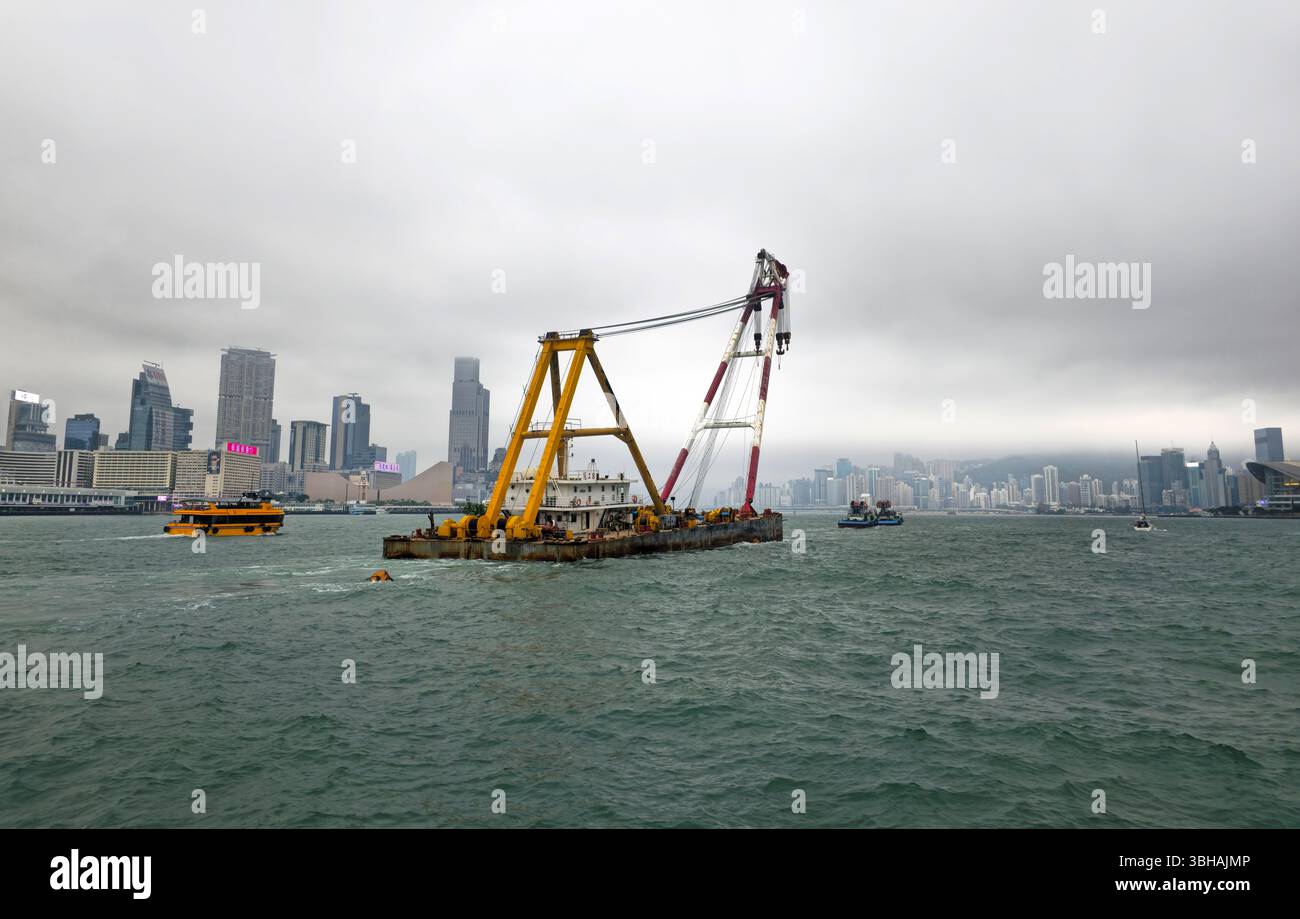 A Tugboat pulling a barge in Victoria Harbour in Hong Kong. - Smartphone Captured Stock Image