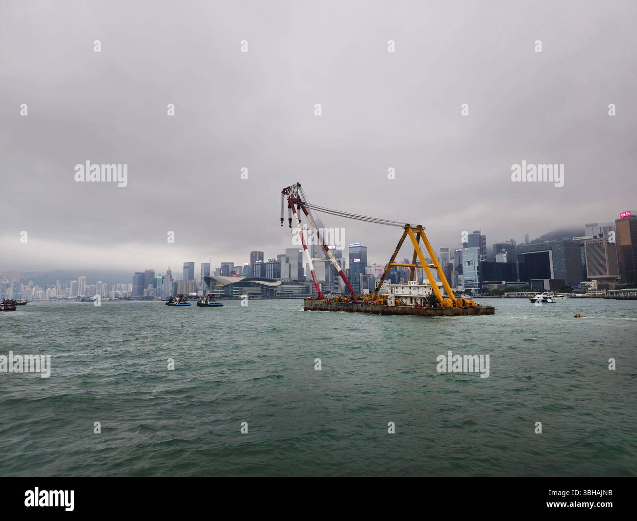 A Tugboat pulling a barge in Victoria Harbour in Hong Kong. - Smartphone Captured Stock Image