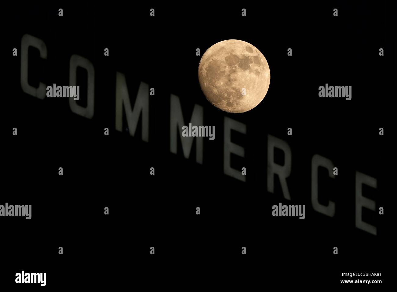 The moon rises beyond a bank building Sunday, June 8, 2025, in downtown ...