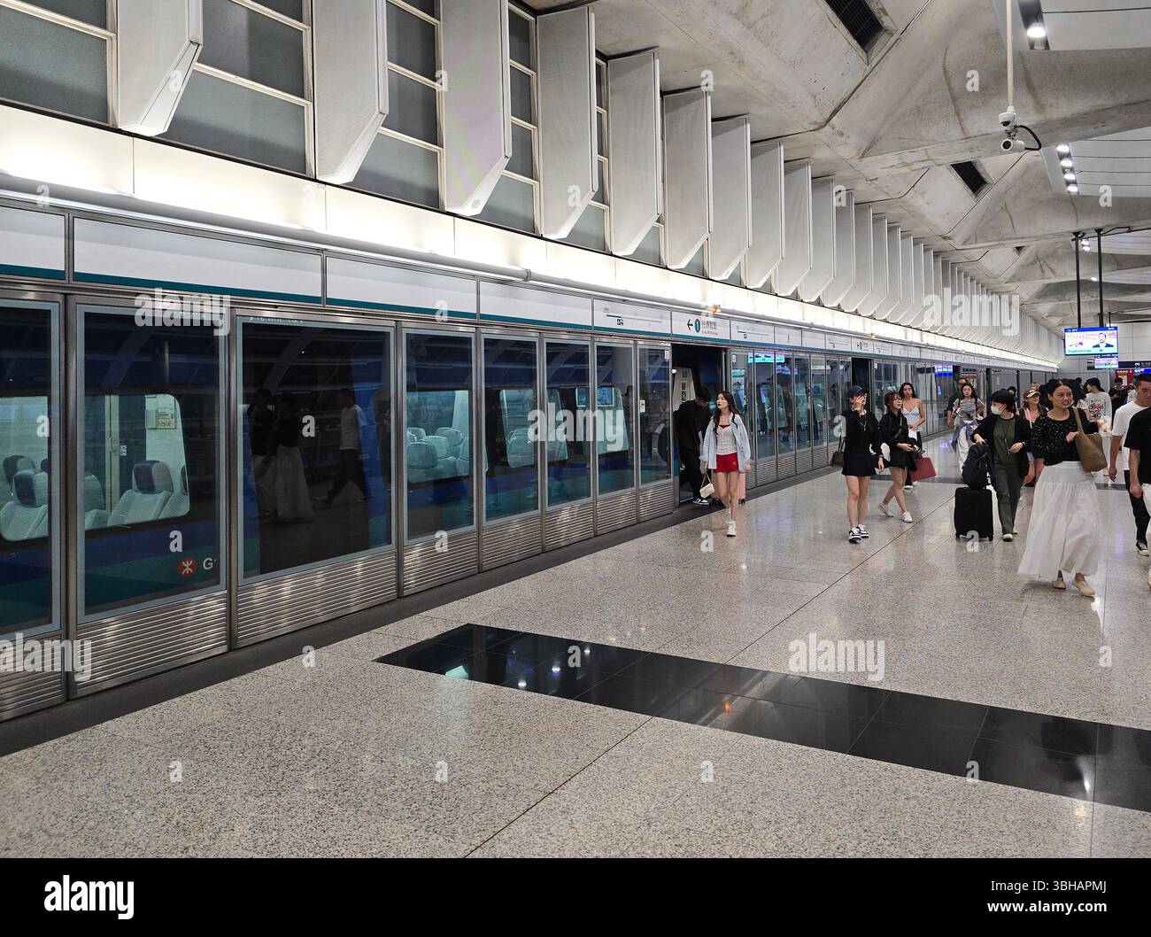 Passengers leaving the Airport Express train at Hong Kong Station, Hong Kong. - Smartphone Captured Stock Image
