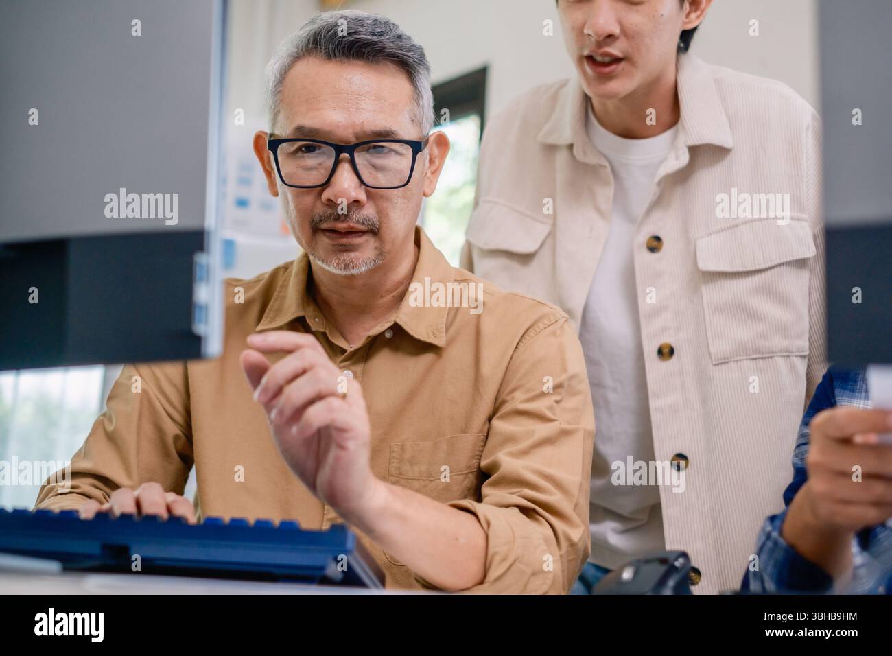 Asian senior bootcamp team asking and  learning programming with software training and whiteboard collaboration Stock Photo