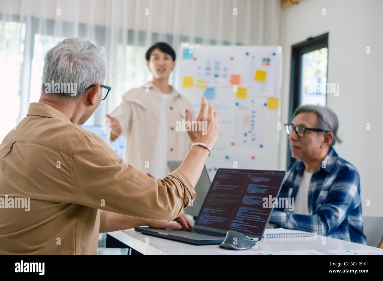 Asian senior bootcamp team asking and  learning programming with software training and whiteboard collaboration Stock Photo
