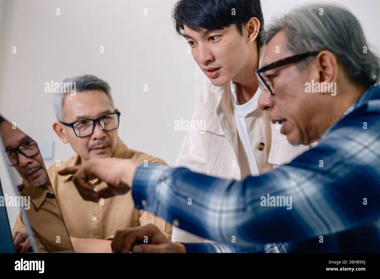 Asian Instructor Teaching Senior in Software Programming and Training Collaboration Stock Photo