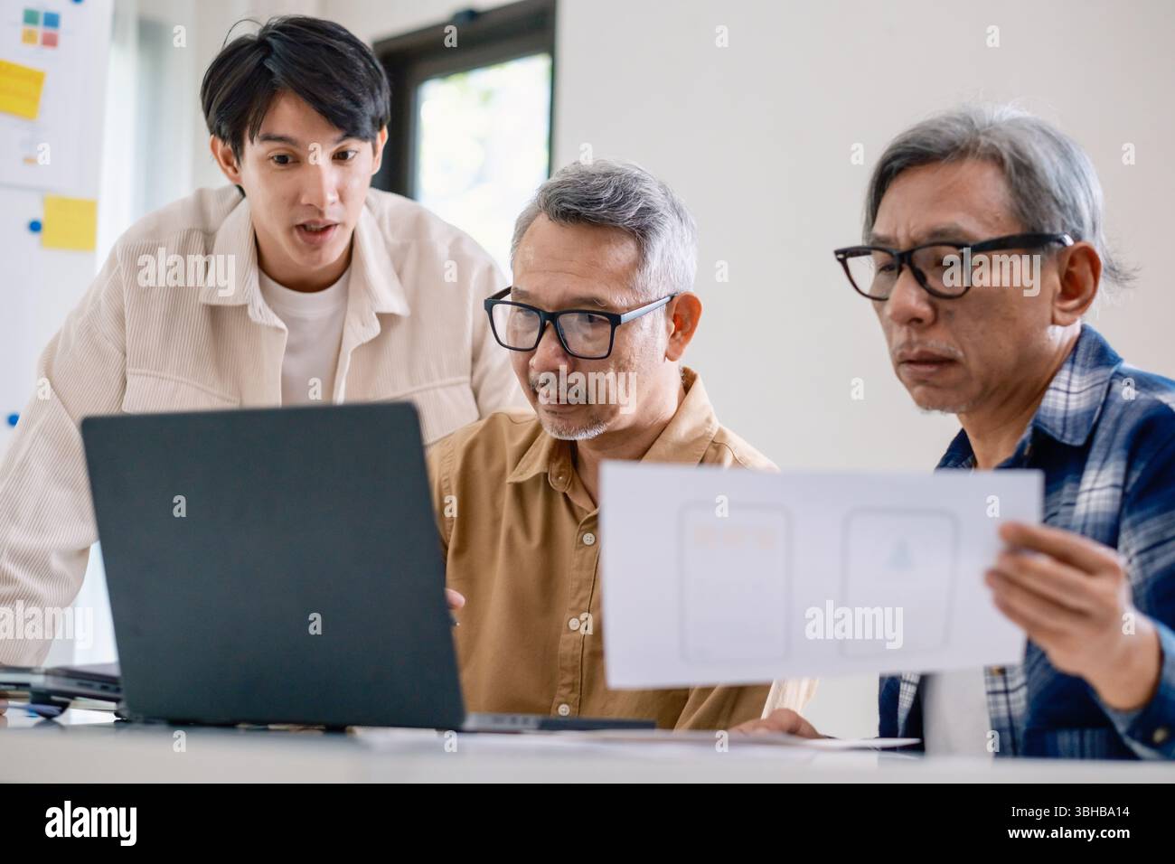 Asian Instructor Teaching Senior in Software Programming and Training Collaboration Stock Photo
