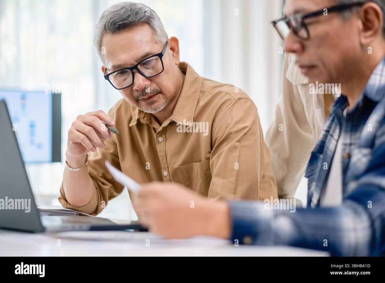 Asian Instructor Teaching Senior in Software Programming and Training Collaboration Stock Photo