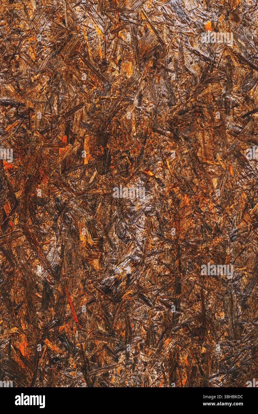 Oriented strand board (OSB) surface as background, brown painted wood, vertical image Stock Photo