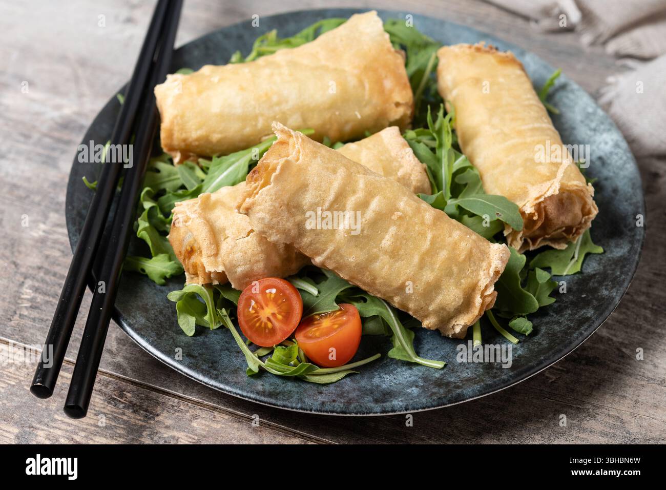 Crispy vegetables spring Rolls on wooden table Stock Photo