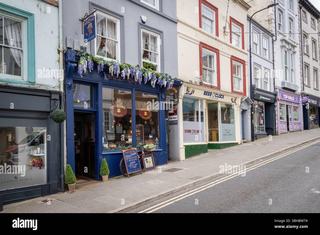 A row of shops along Flowergate in Whitby, including Sherlock's Coffee House. Stock Photo
