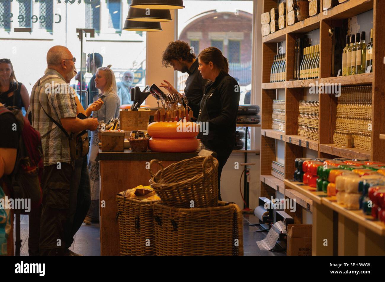 Busy Dutch Cheese Shop with Customers and Staff Inside Amsterdam Store Stock Photo
