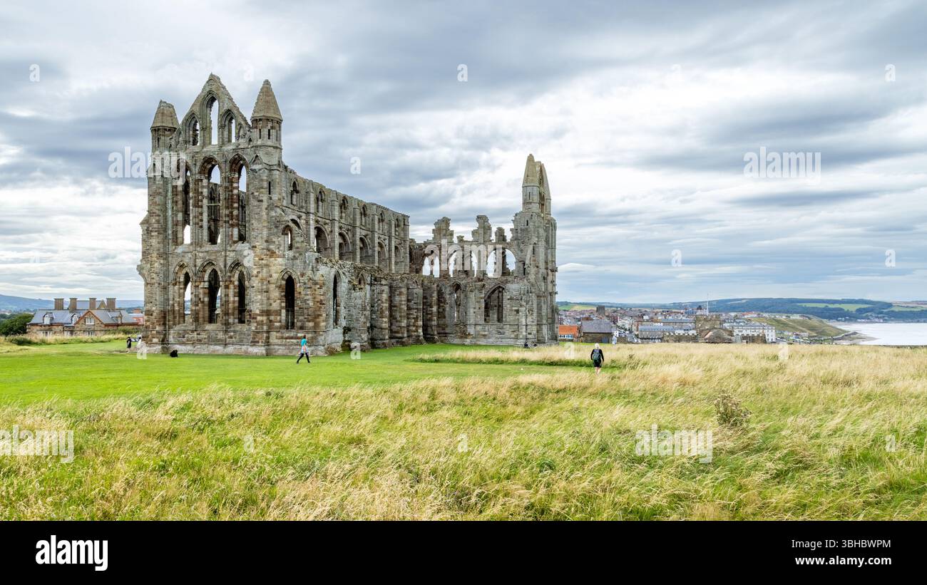 Whitby Abbey's dramatic ruins tower above the Yorkshire coast, famed for inspiring Bram Stoker’s Dracula and rich with monastic history. Stock Photo