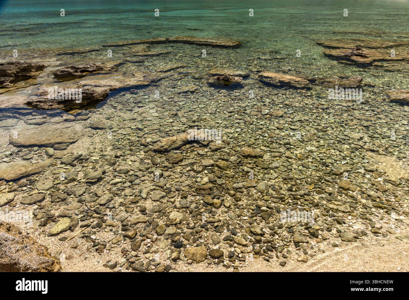 Panorama of the bay with the Vela Luka beach below, view of the beach from the top of the mountain, rocky trail leading to the picturesque beach Stock Photo