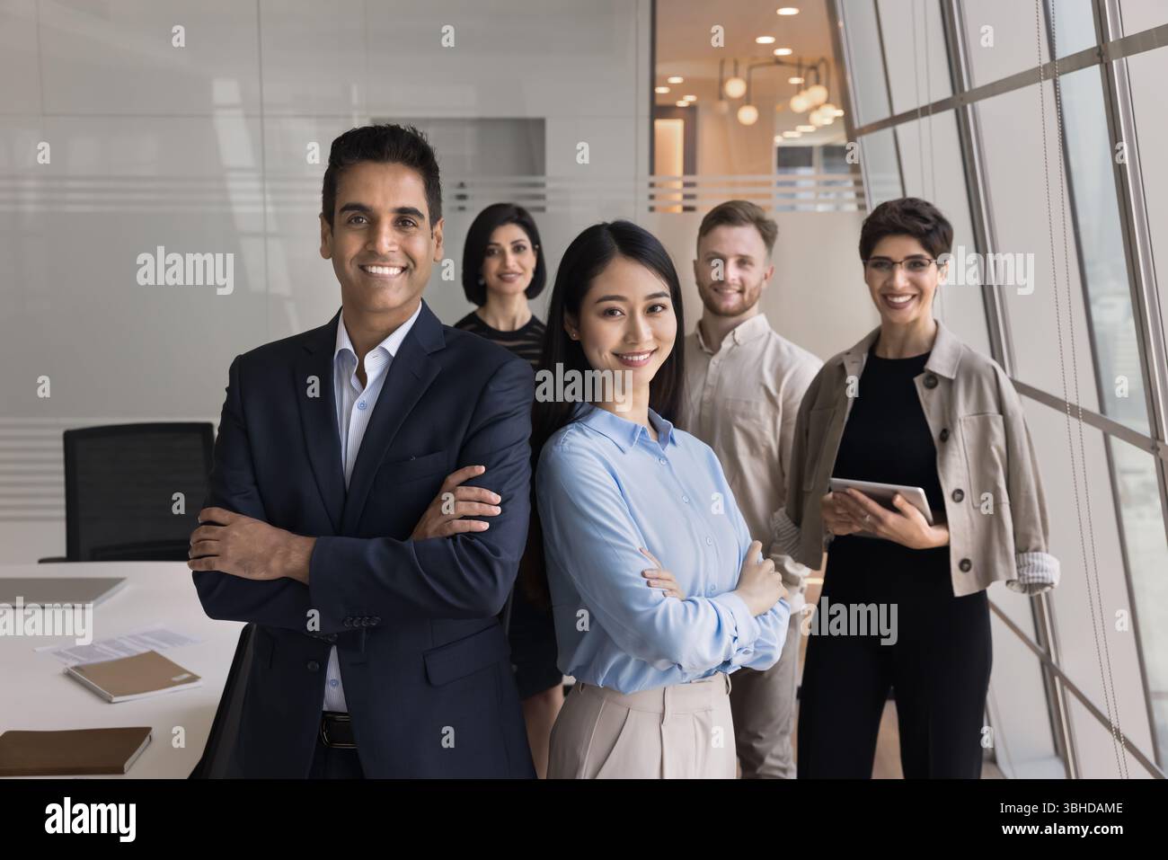 Team led by two executive managers posing in office Stock Photo