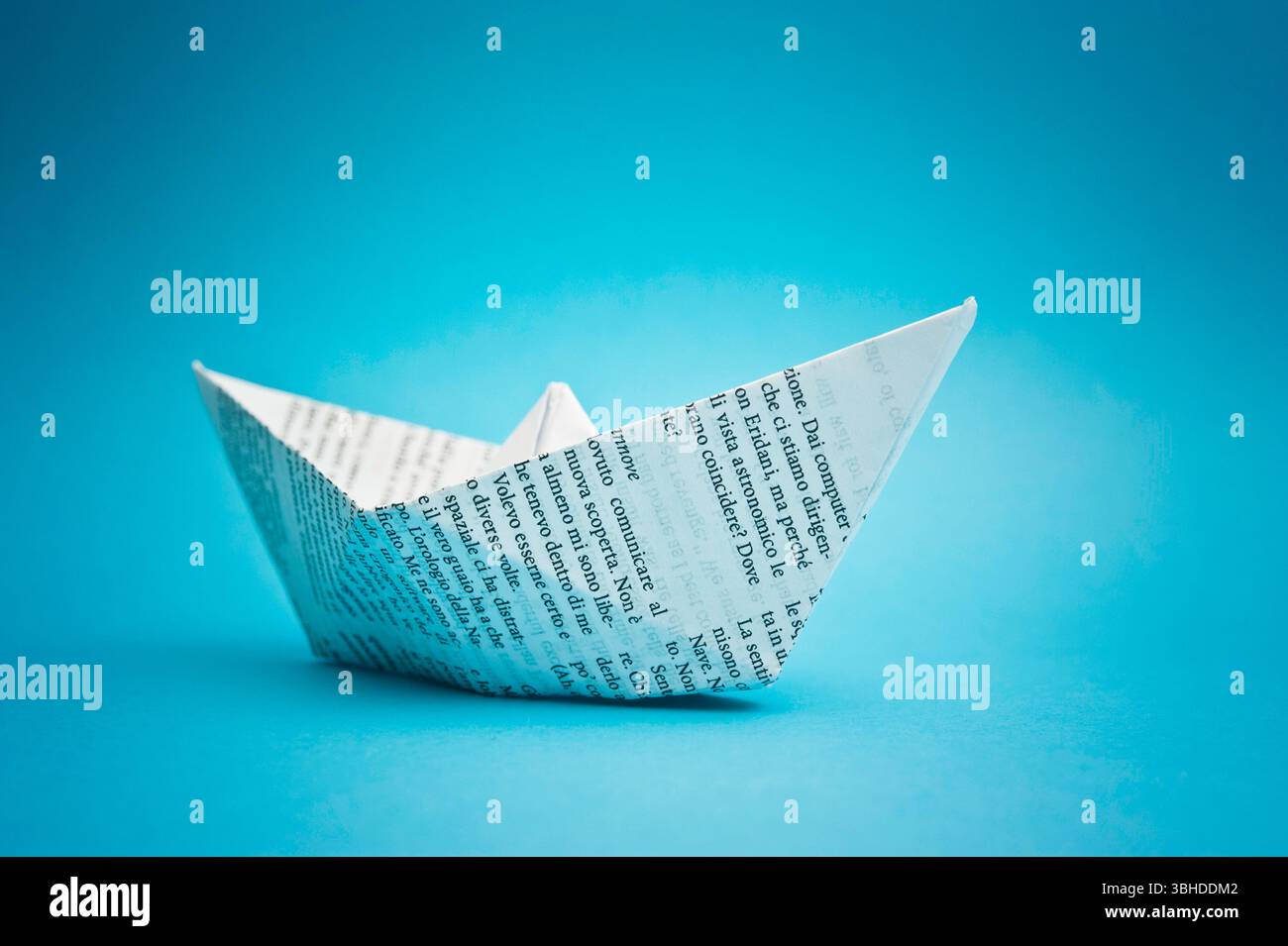 paper ship on blue background Stock Photo