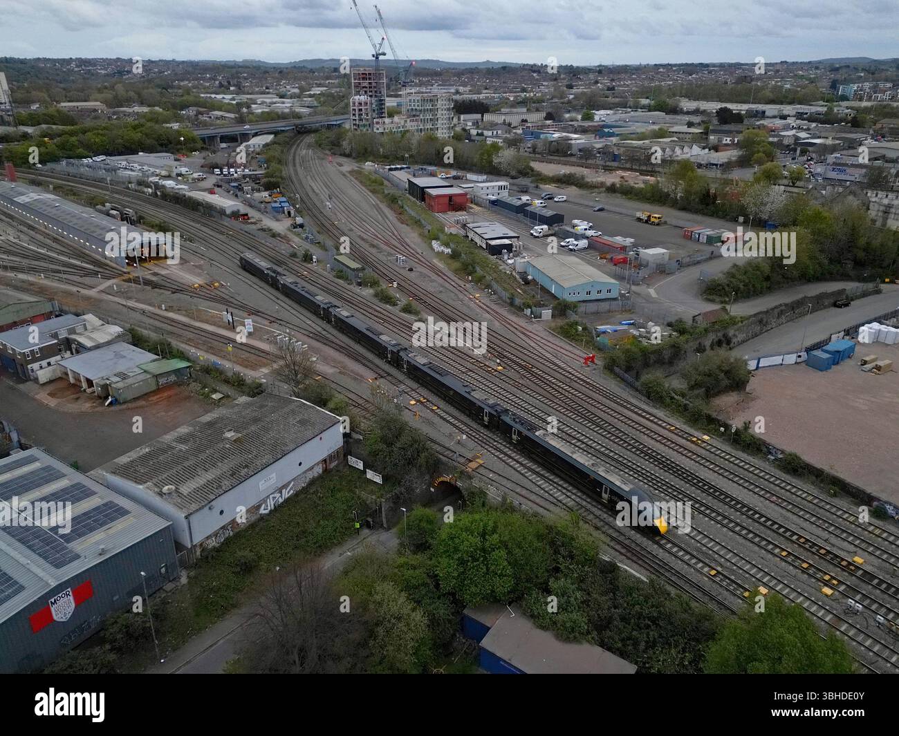 Aerial Drone view of a GWR 800 class train passing Barton Hill Train maintenance depot and Bristol East Junction, Bristol UK 14th April 2025 Stock Photo