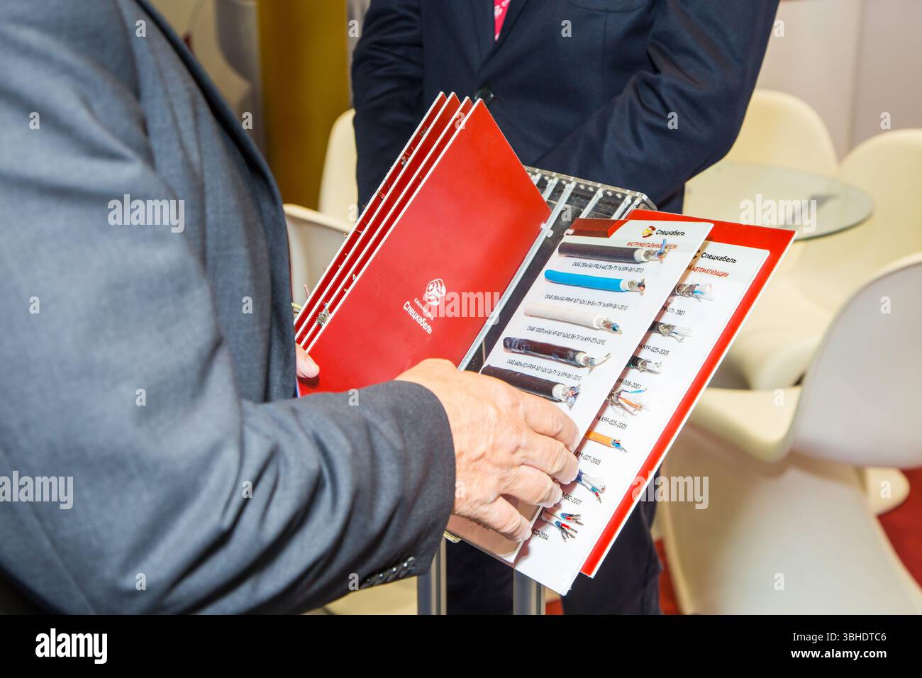moscow, russia, 28.06.2017 A man is holding a red book with a blue cover. The book is titled "The World of Wires". The man is standing next to a woman Stock Photo