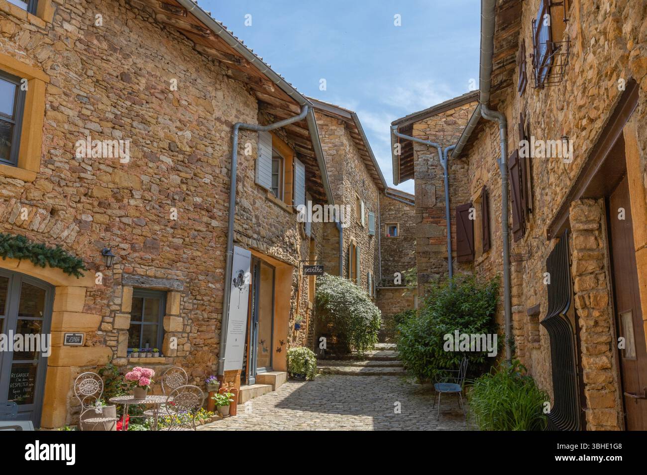 Tyre-Laine street lined with houses built with the golden stones typical of the Beaujolais in Oingt, labelled one of France's most beautiful villages. Stock Photo