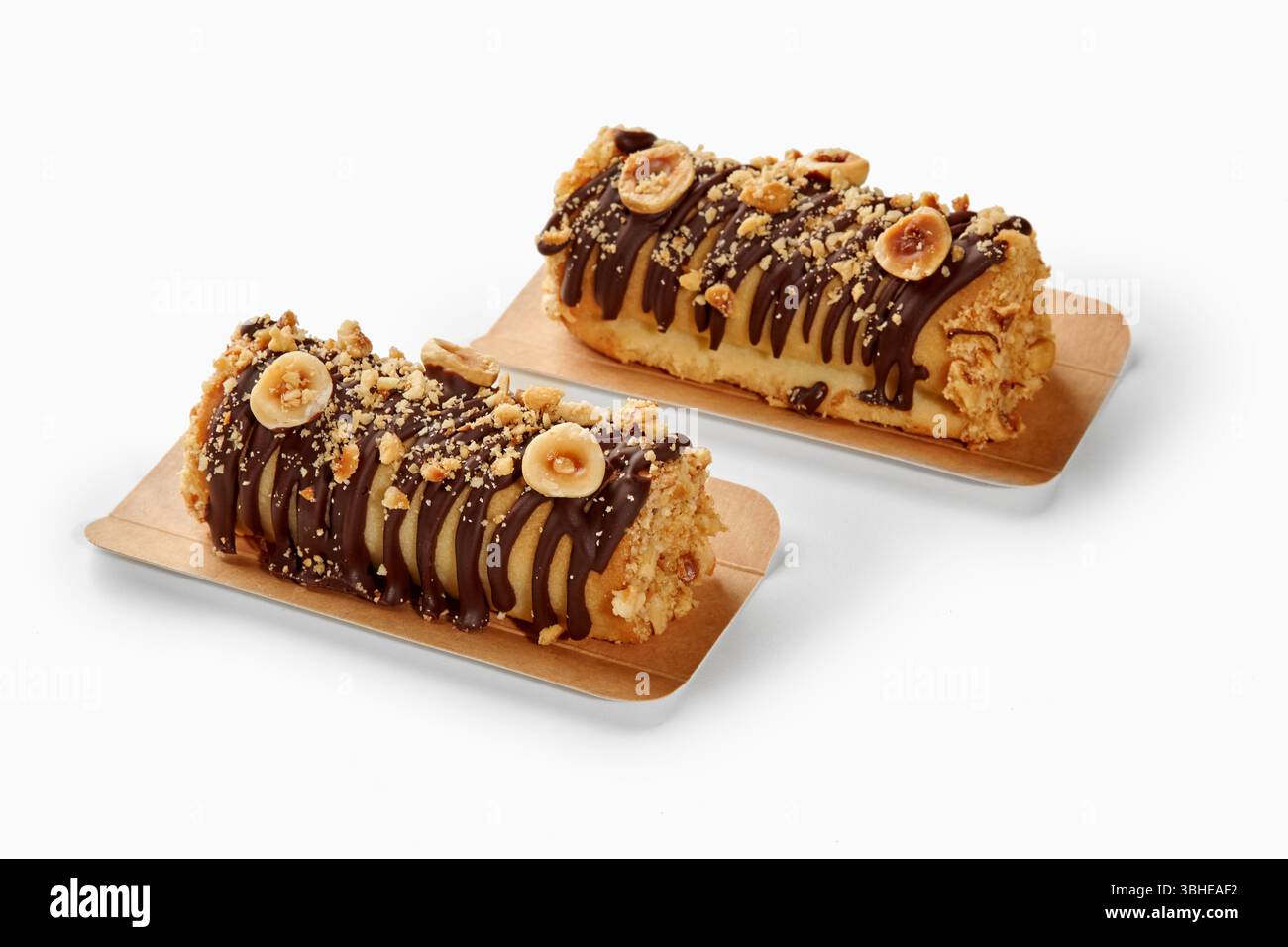 Two delicious mini cakes covered in chocolate and chopped hazelnuts ...