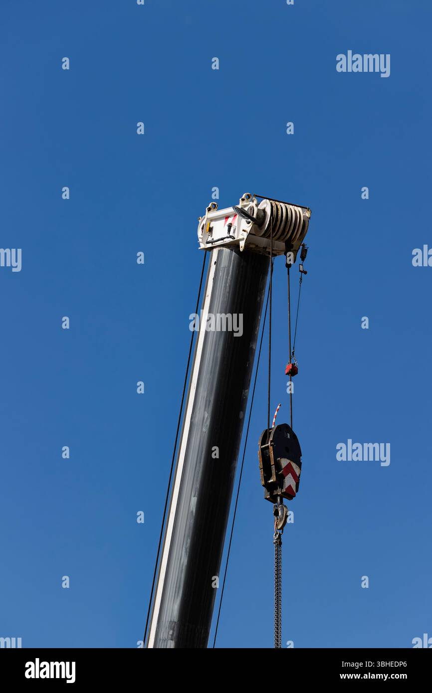 Mobile crane boom with wire rope block, hook and suspended chain at ...