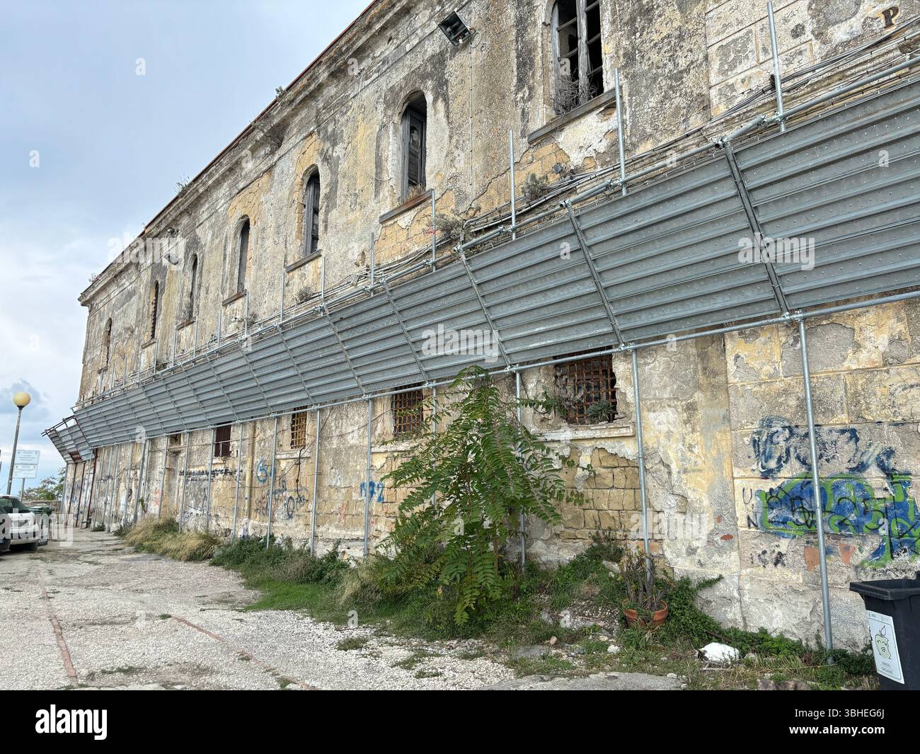 The abandoned prison on Procida Island, a haunting yet intriguing ruin overlooking the sea, rich with history and coastal atmosphere. Stock Photo