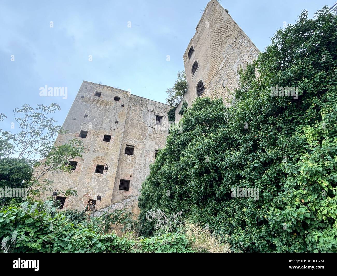 The abandoned prison on Procida Island, a haunting yet intriguing ruin overlooking the sea, rich with history and coastal atmosphere. Stock Photo