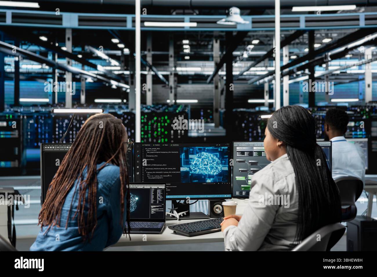 Data center engineering team working together, using AI visualization to oversee automated repetitive tasks. Server farm teamworking colleagues modifying systems based on data analytics graphs Stock Photo