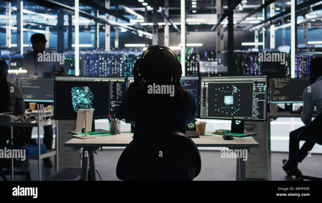 Data center engineer using algorithms to analyze large datasets, putting on headphones. Server farm IT professional using artificial intelligence to recognize data patterns listening music, camera A Stock Photo