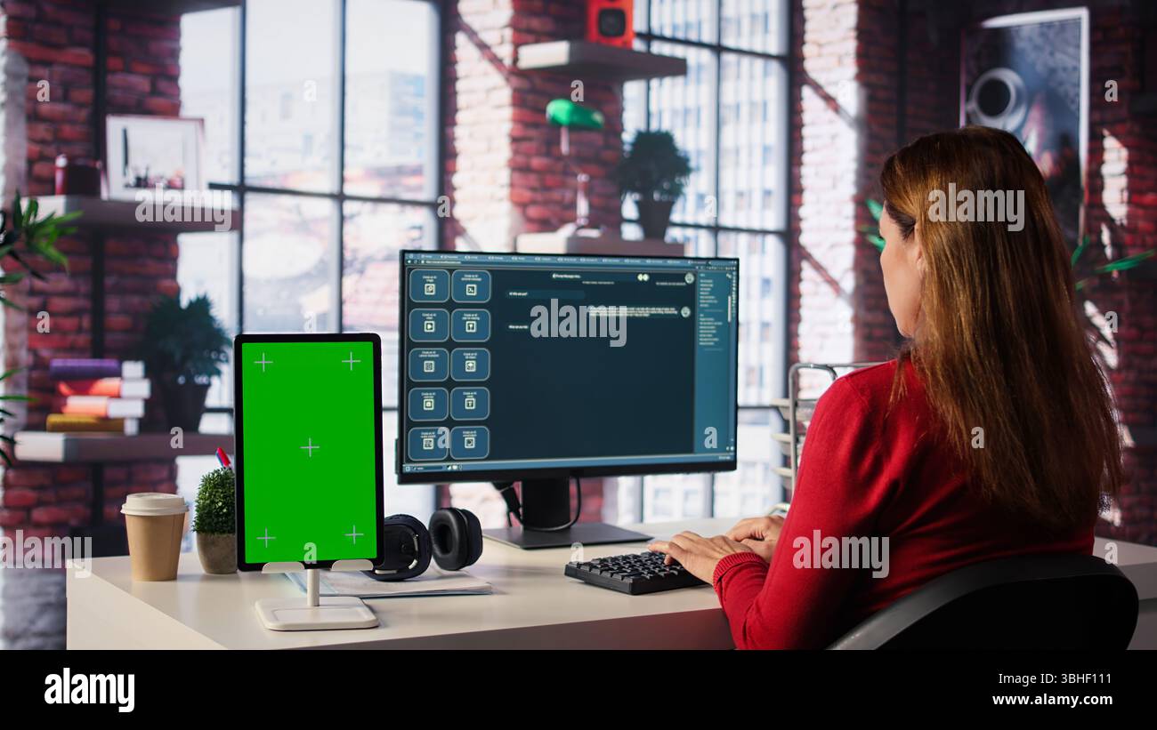 Freelancer interacting with smart AI virtual assistant next to mockup screen, using innovative chatbot web interface. Machine learning enhances productivity through advanced algorithms. Camera B. Stock Photo