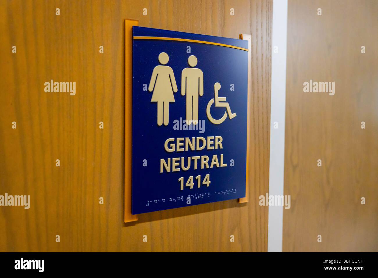 Close-up view of a gender-neutral bathroom sign with inclusive symbol and clear lettering Stock Photo