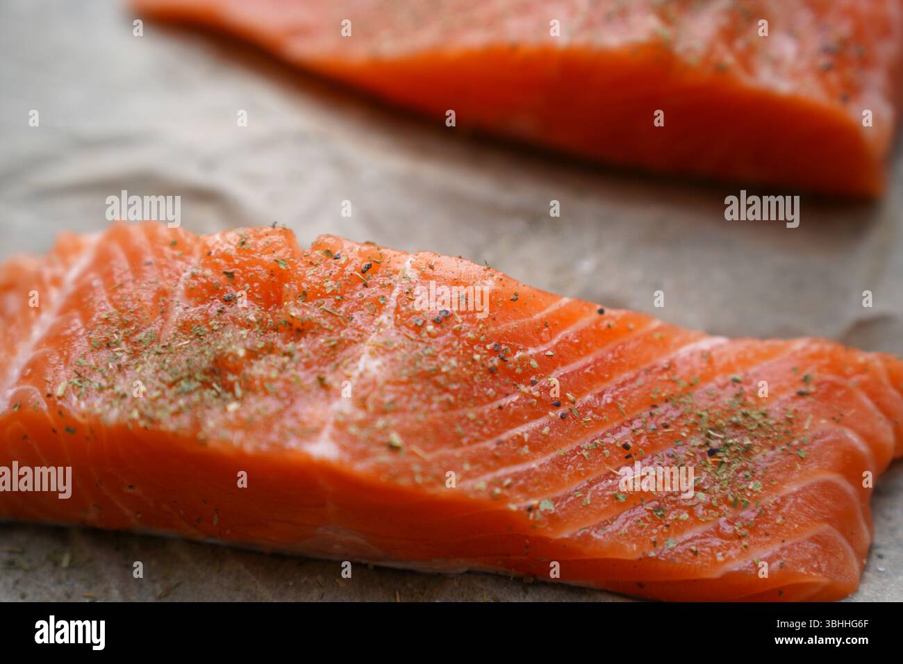 Fresh Raw Salmon Fillets with Herbs on Parchment Paper Stock Photo - Alamy