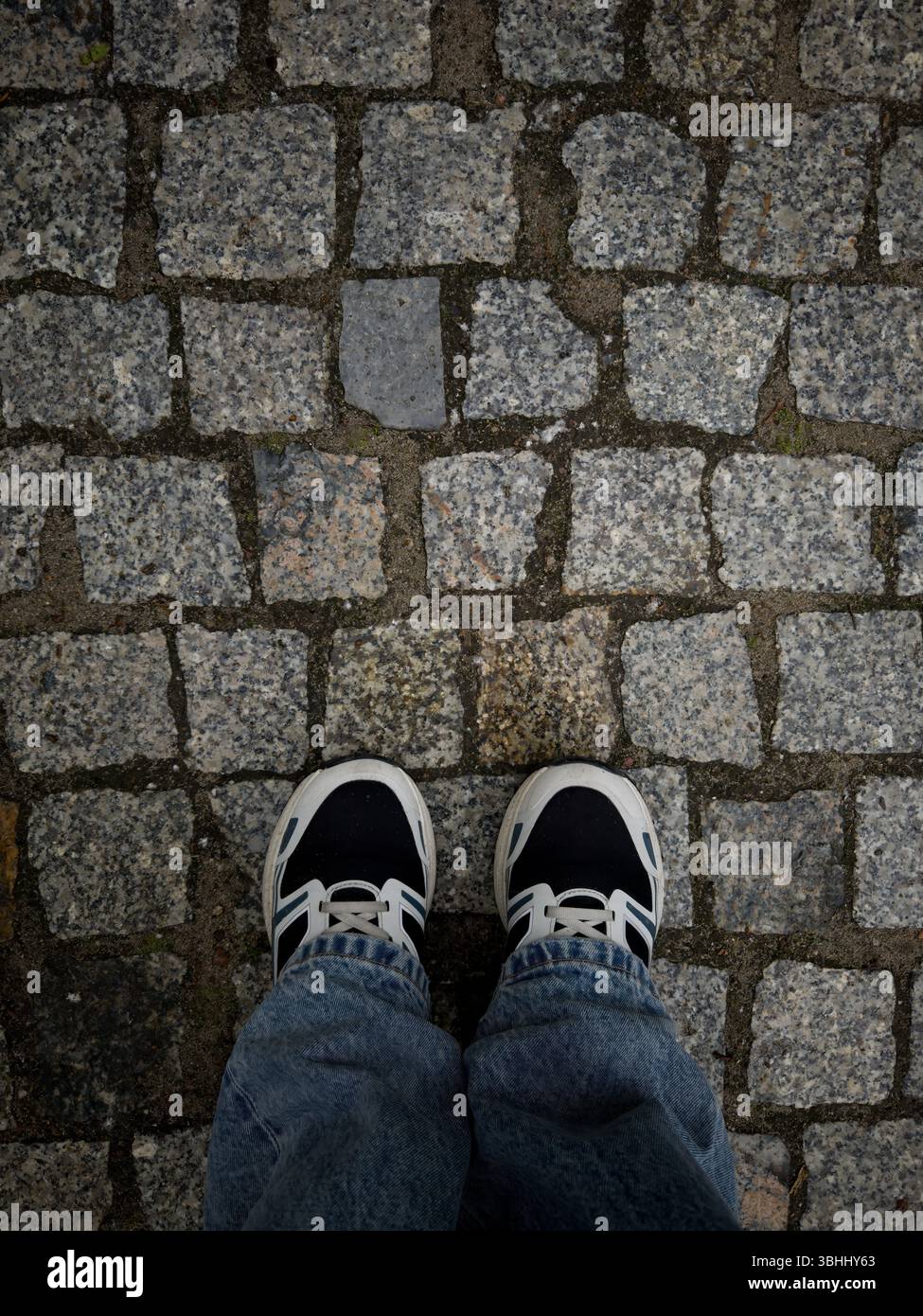 Close up of cobblestone street. Old road paved with granite stones - Smartphone Captured Stock Image