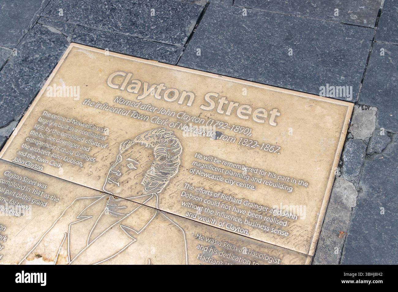 Bronze plaque on Clayton Street in Newcastle commemorating John Clayton's contributions with historical text and engraved portrait Stock Photo
