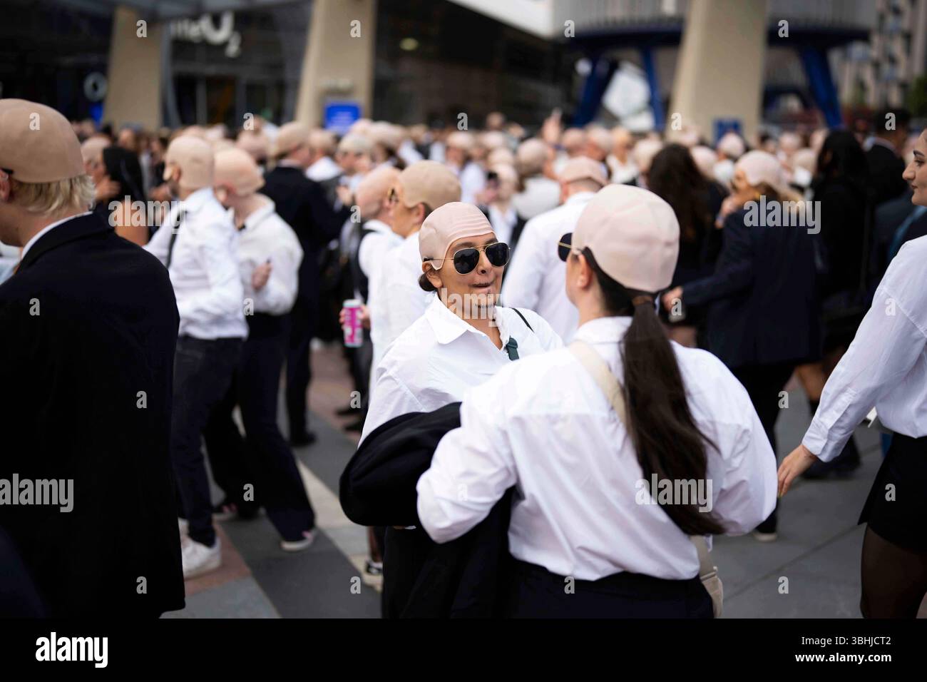 Fans dance in front of the O2 Arena prior to a performance by Pitbull ...