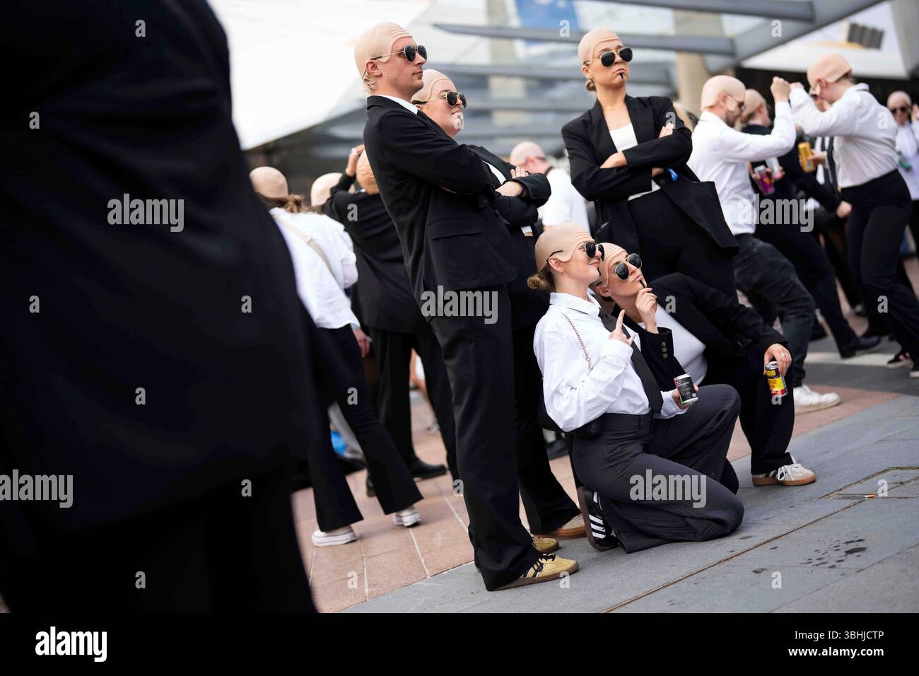 Fans dance in front of the O2 Arena prior to a performance by Pitbull ...