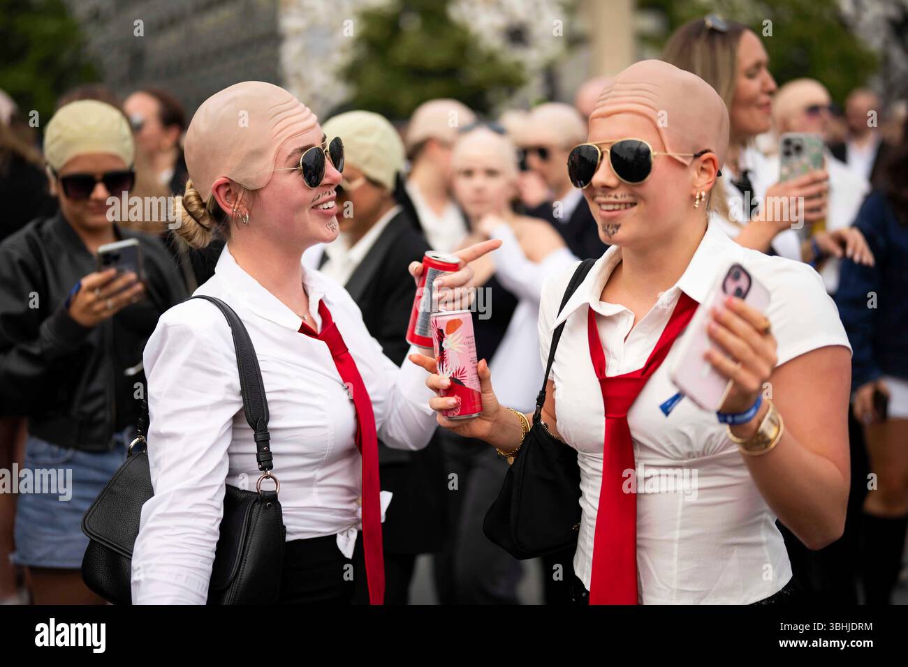 Fans dance in front of the O2 Arena prior to a performance by Pitbull ...