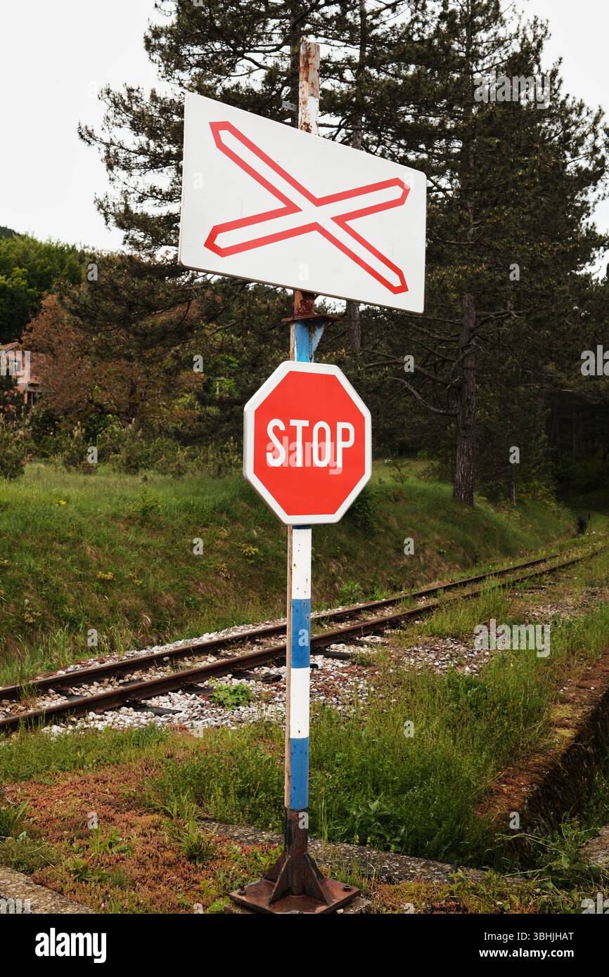 Sign Track Sign Railroad crossing sign and STOP sign next to train tracks in Mokra Gora ...