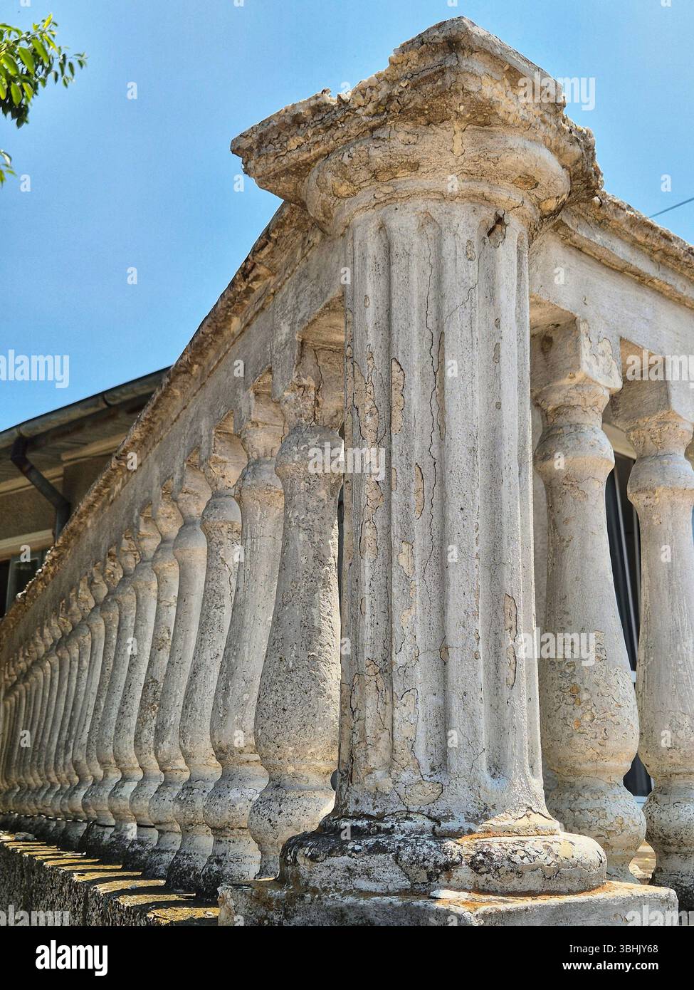 A fragment of an ancient or architecturally significant building. part of a facade. exquisite architectural details, pilasters and carved elements - Smartphone Captured Stock Image