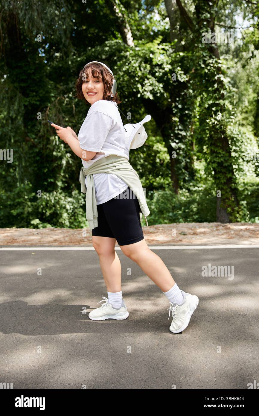 Woman walks along sunlit path hi-res stock photography and images - Alamy